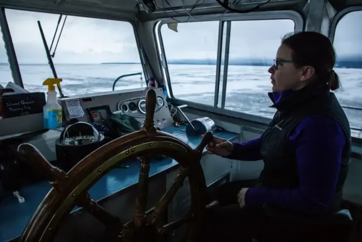 Capt. Shannon Mager steers a ferry boat through open waters of Lake Superior from Bayfield, Wisconsin, to Madeline Island on Jan. 23, 2020. Image by Zbigniew Bzdak/The Chicago Tribune.&nbsp;​​​​​​​United States, 2020.