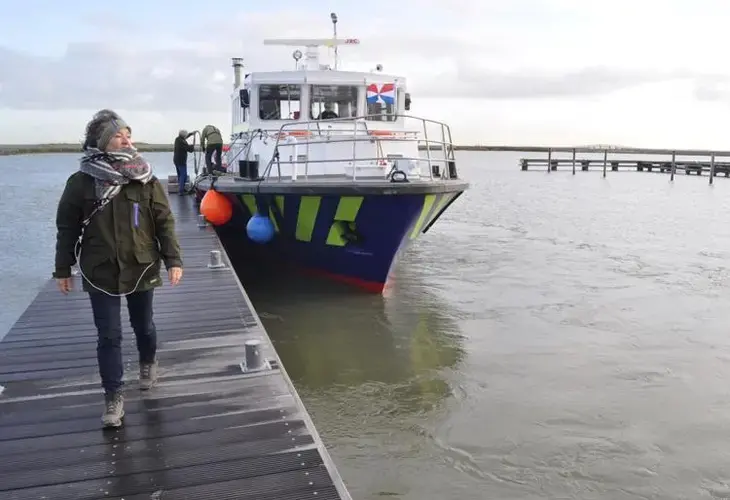 A supply boat staffed by volunteers docks at the Marker Wadden, a series of artificial islands north of Amsterdam. The islands are part of a project aimed at restoring a lake harmed by a large dam. Image by Tristan Baurick / Times-Picayune&nbsp;| The Advocate.&nbsp;The Netherlands, 2020.