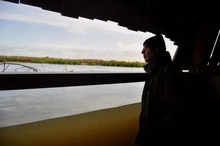 Roel Posthoorn, director of the Marker Wadden, looks out from a partially submerged shelter on an artificial island north of Amsterdam. Image by Tristan Baurick / Times-Picayune | The Advocate. The Netherlands, 2020.