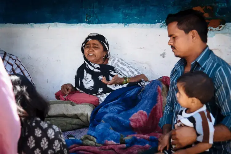 Munni bi lies on her bed outside her house in Annu Nagar. Image by&nbsp;Raj Sarma. India, 2018.