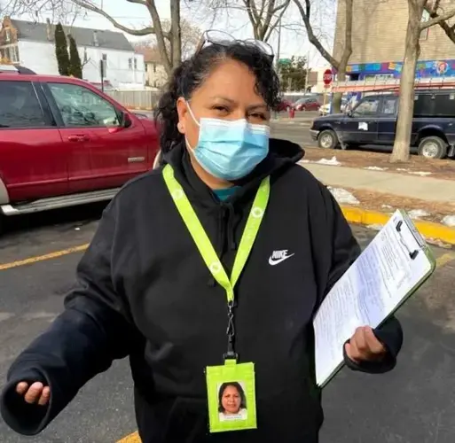 Martina Sanchez, a promotora de salud, stands outside a Back of the Yards laundromat where she shared information with and fielded questions from residents about COVID-19. Image by&nbsp;María Inés Zamudio / WBEZ News.