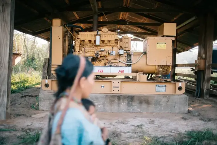 A Chiman woman walks through the light engine that San Ambrose left intact. She is on her way to harvest oranges. Image by Manuel Seoane. Bolivia, 2019.