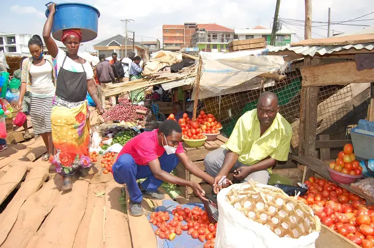 Traders at Ggaba market have constructed a raised floor on top of water using timber. They think this will work for a mean time with hope that the ground will soon dry. Image courtesy of&nbsp;Noah Omuya. Uganda, 2020.
