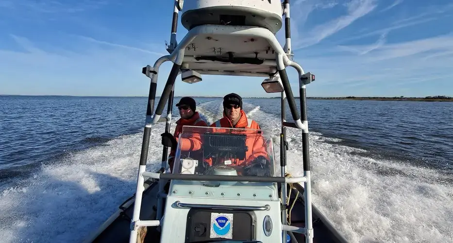 Clay George, left, and Trip Kolkmeyer, wildlife biologist with the Georgia Department of Natural Resources, aboard a NOAA Zodiac. Image by David Abel/The Boston Globe&nbsp;Staff. Canada, 2019.