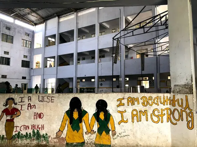 Murals line the low walls surrounding the school. Image by Annalisa Merelli. India, 2018.&nbsp;