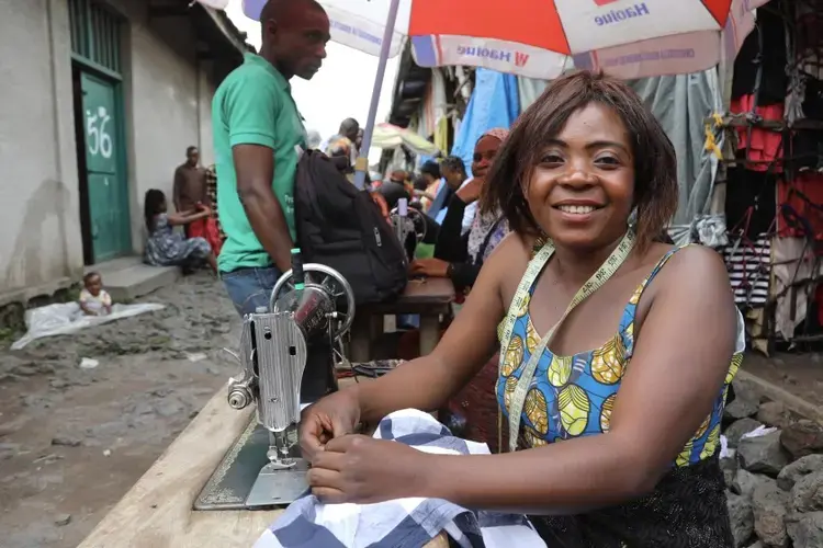 Kajang Anuaritte, a 27-year-old tailor and mother of five children, works out of Virunga market in Goma, Congo. “There’s hundreds of us here packed together, it will spread easily,” she said of the coronavirus. Image by Peter Yeung / LA Times. Congo, 2020.