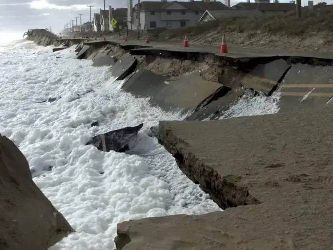 Waves lap at N.C. 12 in Kitty Hawk at low tide Oct. 10, 2016. This section has since been repaired. Image by Kip Tabb. United States, 2016.