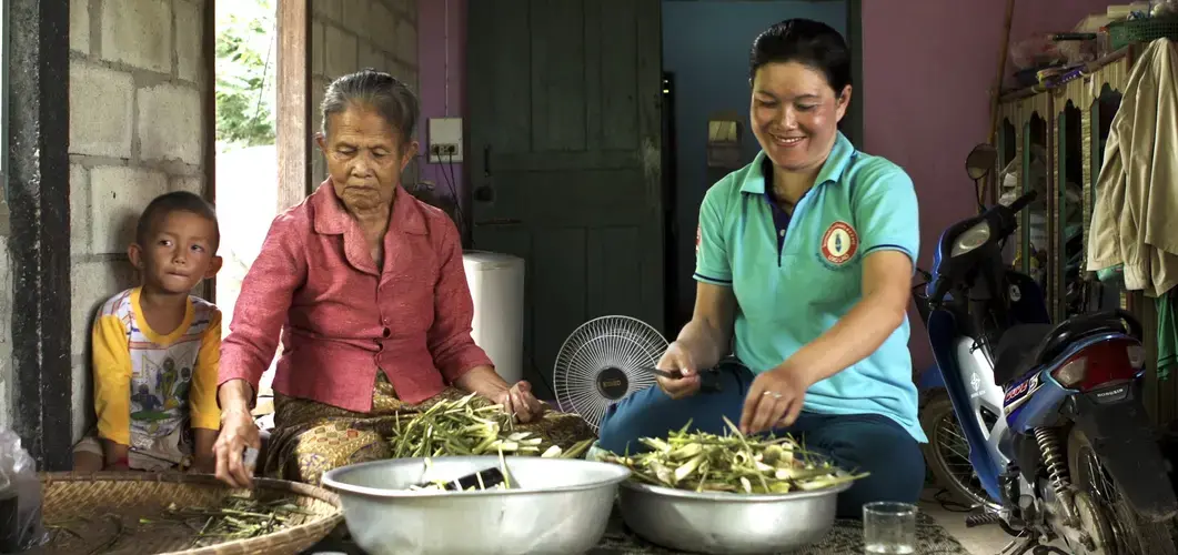 Phetsamay and her mother prepare dinner in her home. Image by Cyril Eberle. Laos, 2017.