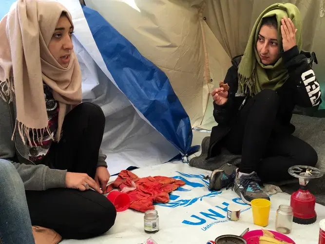 Venus and Wesam Daas, right, at Idomeni refugee camp on the Greece-Macedonia border.  Image by Jeanne Carstensen. Greece, 2016. 