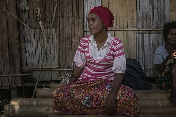 Nira was hospitalized for two months before recovering from the mysterious illness that struck this community of Batek in Kuala Koh. Symptoms included swollen throats and high fever, blurred vision with bloodshot eyes, and head and body aches. The stricken couldn't eat or drink. Image by James Whitlow Delano. Malaysia, 2019.