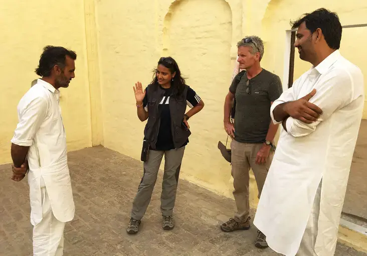 The owner of an old Muslim home, a rarity in this part of India, shows its distinctive layout to&nbsp;Arati Kumar-Rao, Paul Salopek and Sudhir Kukna. Image by Mark Schulte. India, 2018.