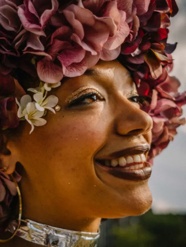 Person with flower crown is illuminated by the sun's glow