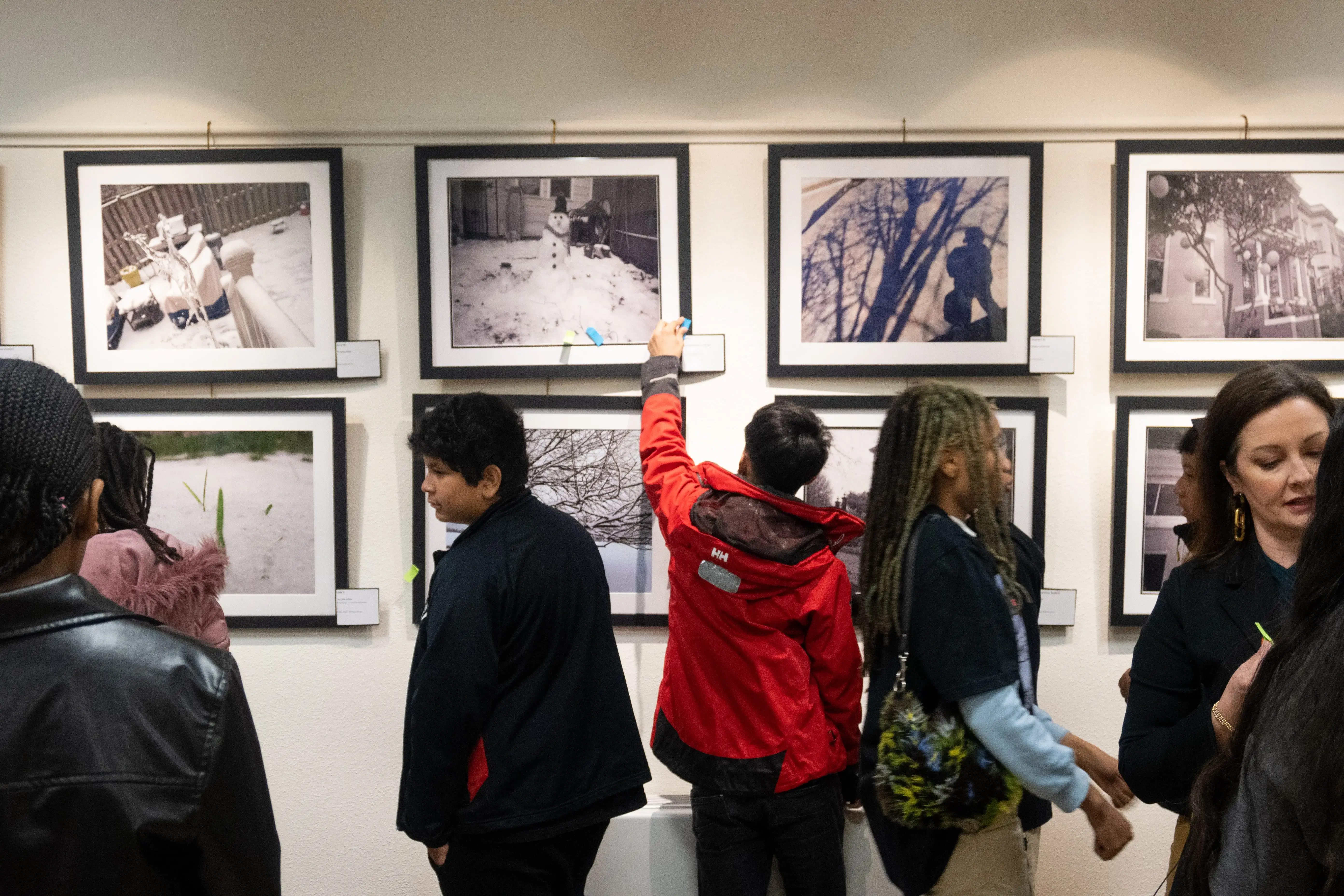 Students explore framed photos in the everyday dc gallery