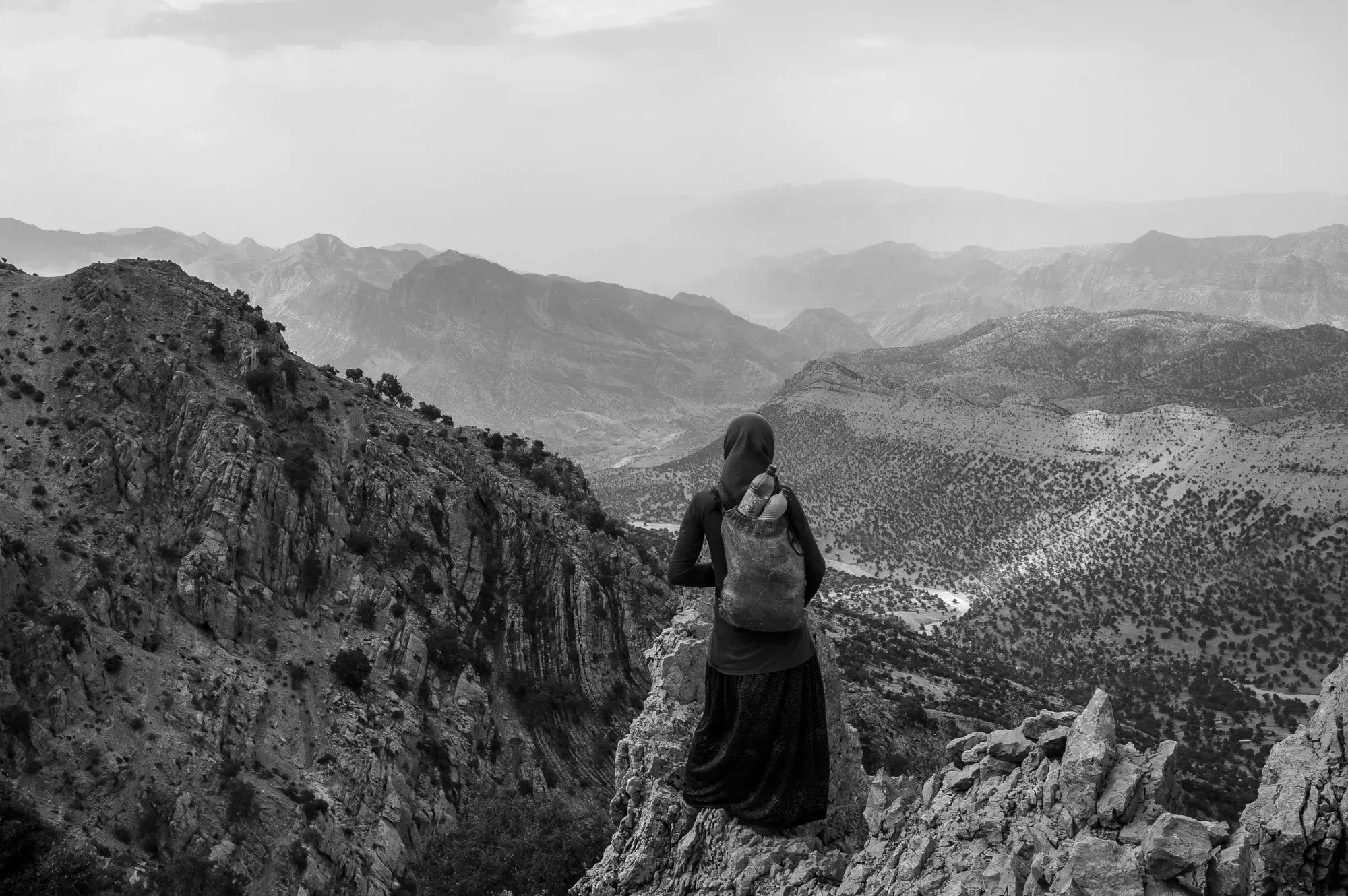Fereshteh, 14, is photographed in the central Zagros Mountains, where her tribe spends spring and summer. They travel many hours on rough paths throughout the year, from pasture to pasture—and then there's the yearly 10-hour journey from their summer home to their winter home. She says she does not like the nomadic way of life but feels she has no choice but to accept and endure it. Image by Enayat Asadi/NPR. Iran, 2022.