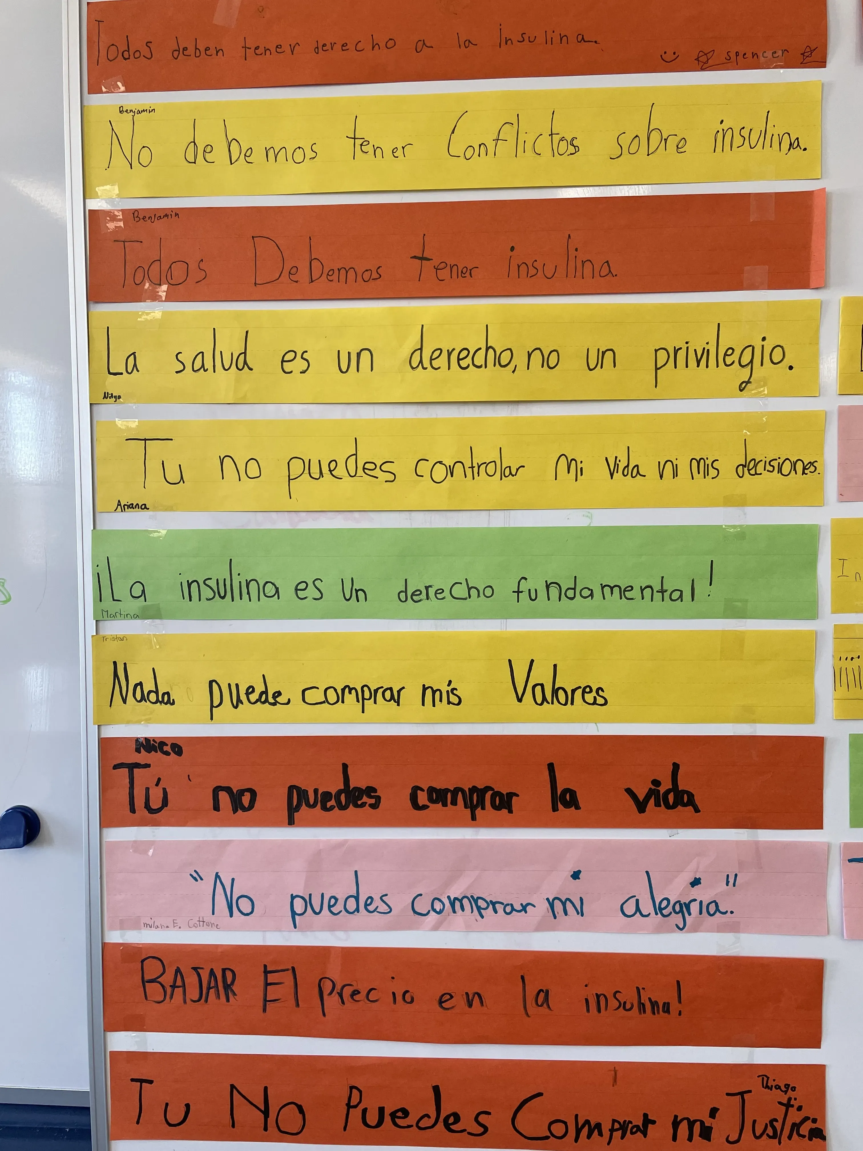 colorful strips of paper on board with Spanish phrases relating to the right to healthcare