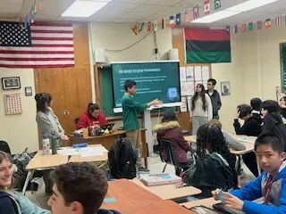 students giving presentation at front of classroom