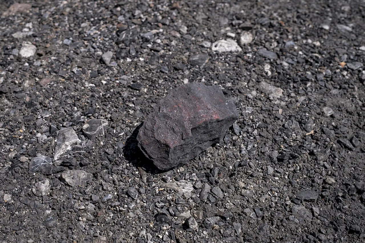 A larger rock among pebbles.