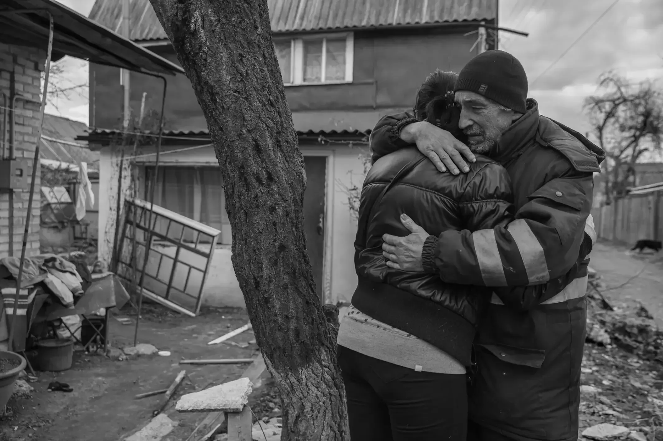 A grieving Iryna Havryliuk receives an embrace.