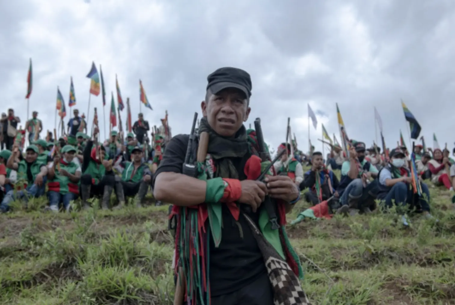 A man stands in front of other Indigenous guards 