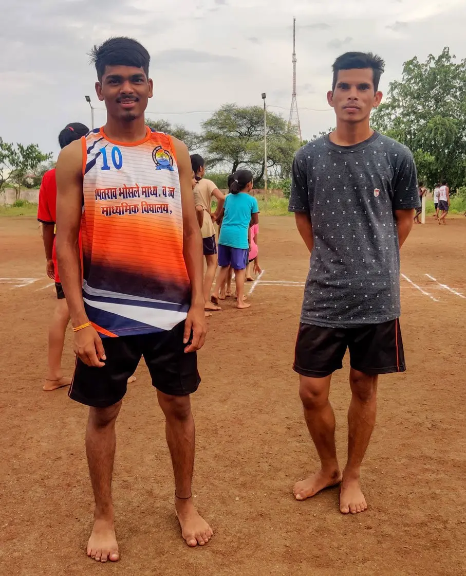 Two men stand next to each other for a photo