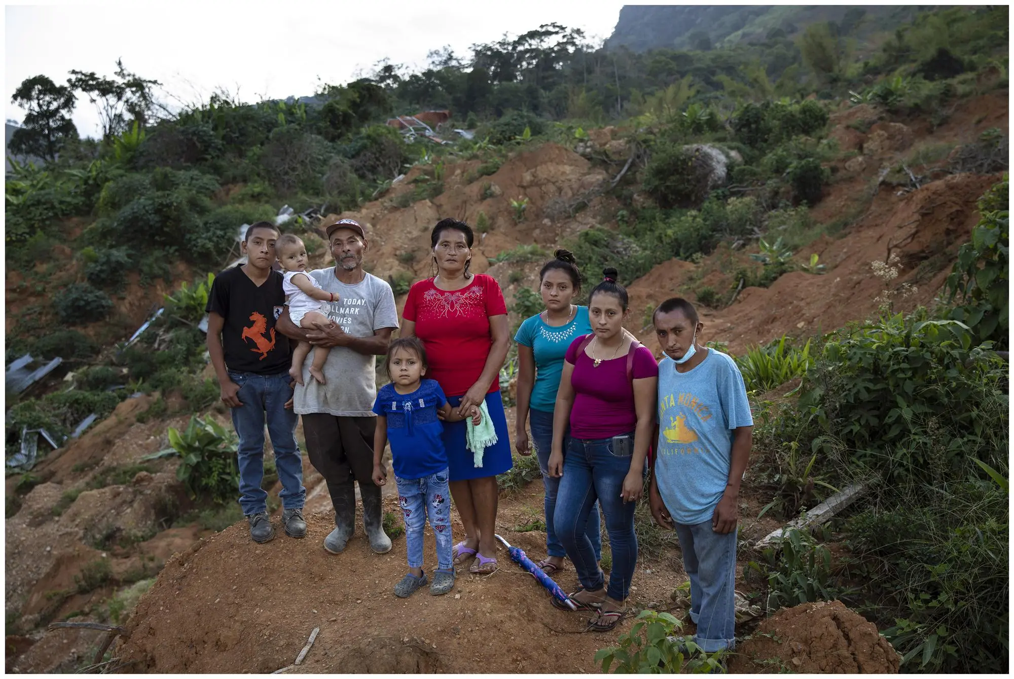 Family poses on hillside