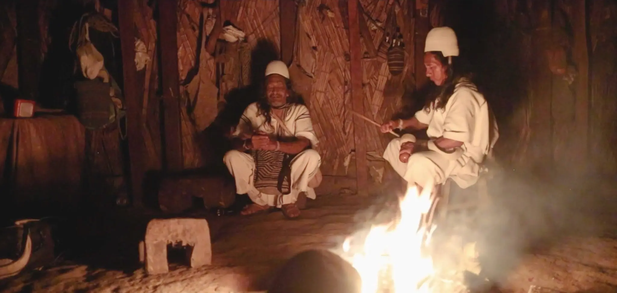 Arhuaco communicators work over a fire