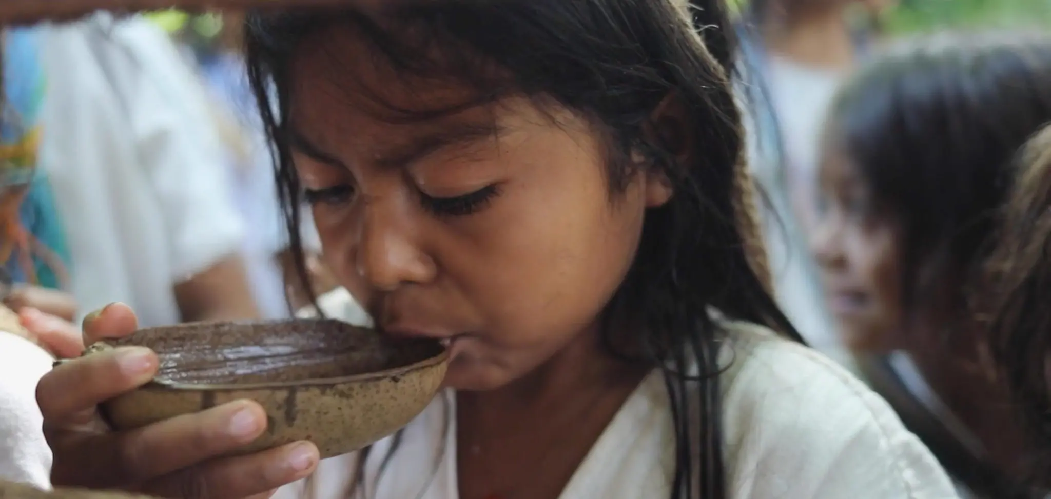 Young girl drinks plant infusions