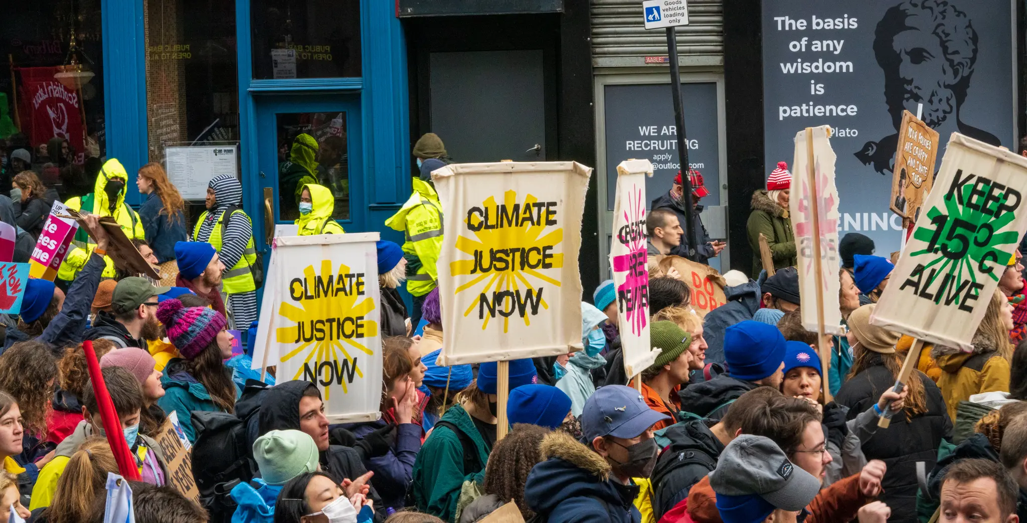 crowd hoists signs into the air