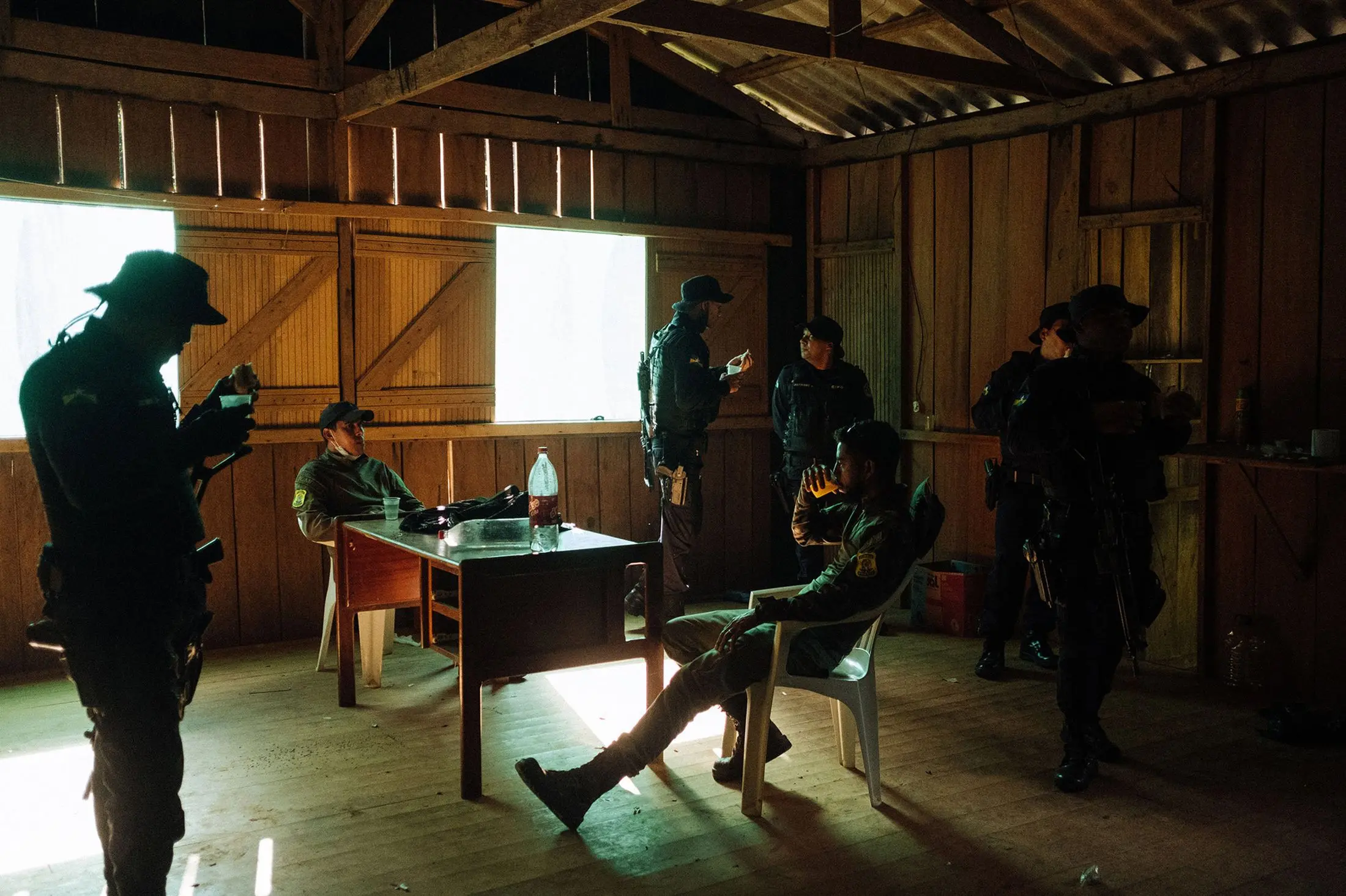 Rangers and police officers sit at a base together