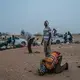 Men pray before they start the treacherous journey across the desert from the Agadez to Libya. Image by Nichole Sobecki. Niger, 2017.