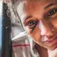 Yusbelis Bustamante, 23, cries while showing her injuries from a fight with another inmate at La Yaguara Detention Center, Caracas. She is 4 months pregnant, but in her seven weeks of detention, she had not received any medical checkups. Image by Ana María Arévalo. Venezuela, 2018.