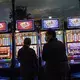 People stand in front of electronic slot machines in a Casino in Las Vegas, Monday, Nov. 9, 2020.&nbsp;Image by Wong Maye-E / AP Photo. United States, 2020.