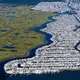 The subdivision Beach Haven West was carved out of a New Jersey salt marsh beginning in 1945. The passage of the state Wetlands Protection Act of 1970 prevented additional loss of wetlands in New Jersey. Scientists with Rutgers University in New Jersey forecast a rise of sea level along the state’s shoreline of as much as 106 centimeters by 2100. That would inundate a large percentage of this community of almost 4,000 people. Image by Alex MacLean. United States, 2019.