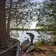 Duane Hanson prepares to launch one of his many canoes on to Whipple Pond at his homestead in the Unorganized Territories in the north woods of Maine near T5 R7 on May 26, 2019. Image by Michael G. Seamans. United States, 2019.