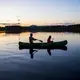 Duane Hanson and Sally Kwan paddle on Whipple Pond at their homestead in the Unorganized Territories in the north woods of Maine near T5 R7 on May 27, 2019. Image by Michael G. Seamans. United States, 2019.