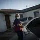 Norma Flores carries her groceries into her home in Henderson, Nev., Tuesday, Nov. 10, 2020.&nbsp;Image by Wong Maye-E / AP Photo. United States, 2020.