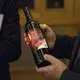 Aaron Hermsen, director of business development for the China Iowa Group gives a bottle of Jasper Winery wine to Terry Branstad, U.S. ambassador to China, during an Iowa Sister States reception on Wednesday, Sept. 20, 2017, in Beijing, China. The wine, with a special Iowa, China label is the same kind that was severed during the state dinner held when China's president Xi Jinping visited Iowa in 2012. Image by Kelsey Kremer. China, 2017.<br />
