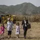 Chris Branstad, hand-in-hand with her granddaughters, Stella and Sofia Costa, leave a groundbreaking ceremony for the China-U.S. Demonstration Farm on Saturday, Sept. 23, 2017, in Luanping County, Hebei, China. Image by Kelsey Kremer. China, 2017.