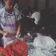 A man makes dumplings at a restaurant serving breakfast on Sunday, Sept. 24, 2017, in Beijing, China. The dumplings were assembled in the doorway and cooked in the street. Image by Kelsey Kremer. China, 2017.