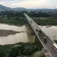 A bridge over Song Hieu River is shown June 12 in the small city of Thai Hoa, Vietnam. It is about 150 miles south of the capital of Hanoi, a five-hour drive. Image by Mark Hoffman. Vietnam, 2019. 