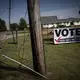 A banner urging citizens to vote is displayed on the side of a street in Jackson Miss. Image by Wong Maye-E / The Associated Press.