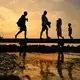 People walked along the iconic Sandwich Boardwalk as the sun sets. Image by John Tlumacki. United States, 2019.
