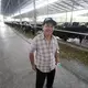 Prateep Kaewnun, who owns Prateep Farms in Pak Chong, Thailand, milks about 400 cows and purchases milk from small farms in the area. Image by Mark Hoffman. Thailand, 2019. 