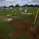 A shovel sits in a freshly-covered grave at the Cedar Hill Cemetery on Saturday, April 18, 2020, in Dawson, Ga. Image by Brynn Anderson / AP Photo. United States, 2020.