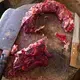 Beef is trimmed on a traditional stump. The stump can play host to harmful pathogens, so the International Livestock Research Institute encourages butcher shops to use steel instead. The owners, however, do not like how metal dulls their cutting tools. Image by Mark Hoffman. Kenya, 2017.