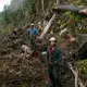 Drew Newman, wearing red suspenders, and Will Karl, in a blue sweatshirt, prepare at the Tuxekan logging site. Image by Joshua Cogan. United States, 2019.