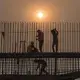 The rapid growth of the city far exceeds any effort to control associated pollution. Here, workers tie rebar at a bridge construction site in downtown Patna. Image by Larry C. Price. India, 2018.