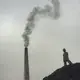 Massive piles of coal are frequent playgrounds for young Dhaka residents. Cleaner-burning and more efficient kiln designs have been developed, but the economic realities of conversion have slowed industry reform here. Image by Larry C. Price. Bangladesh, 2018.
