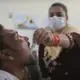 In this Thursday, Oct. 31, 2019, photo, a medic administers medicine to a recovering drug user at a de-addiction center in Kapurthala, in the northern Indian state of Punjab. Researchers estimate about 4 million Indians use heroin or other opioids, and a quarter of them live in the Punjab, India's agricultural heartland bordering Pakistan. These pills, the world had been told, were safer than the OxyContins, the Vicodins, the fentanyls that had wreaked so much devastation. But now they are the root of what the United Nations named “the other opioid crisis,' an epidemic featured in fewer headlines than the American one, as it rages through the most vulnerable places on the planet. Image by Channi Anand / AP Photo. India, 2019.