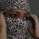 In this Thursday, Oct. 31, 2019, photo, Amandeep Kaur, a former tramadol user, covers her face at the de-addiction at center in Kapurthala, in the northern Indian state of Punjab. Kaur was pregnant when her husband died of a heart attack. She turned to the sex trade to make ends meet. She wanted not to feel, and a fellow sex worker suggested tramadol. She had no idea she’d get addicted, but eventually needed three pills to get through the day. “If I didn’t have it I felt lifeless, my body ached as if I was going to die,” she said, and joined the line stretching from the addiction clinic’s doors. Image by Channi Anand / AP Photo. India, 2019.